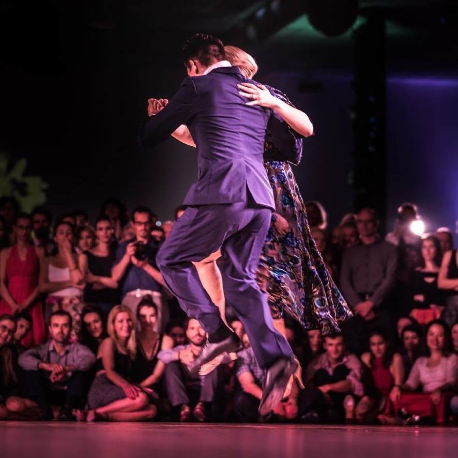 Ivan lifting Sara mid-performance in front of an audience